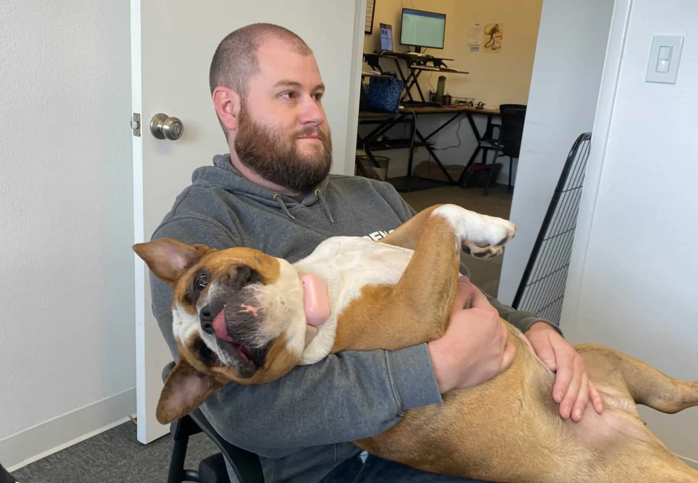 Steven Brockway holding COCO the office bulldog at the Reno Area Home Buyers office